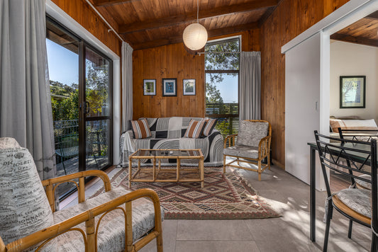 The lounge in Theo's Cottage an overnight stay experience at Ngā Manu nature reserve in Waikanae on the Kāpiti coast.